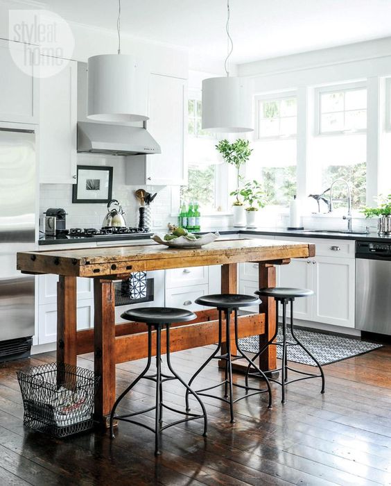 a vintage wooden table with horizontal beams and metal stools create an industrial look and spruce up the space