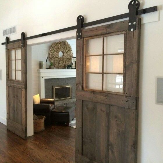 sliding barn doors with clear glass inserts make the look not too bulky and let the light in
