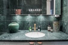 26 a green marble countertop and matching tiles that cover the walls for a stunning modern look