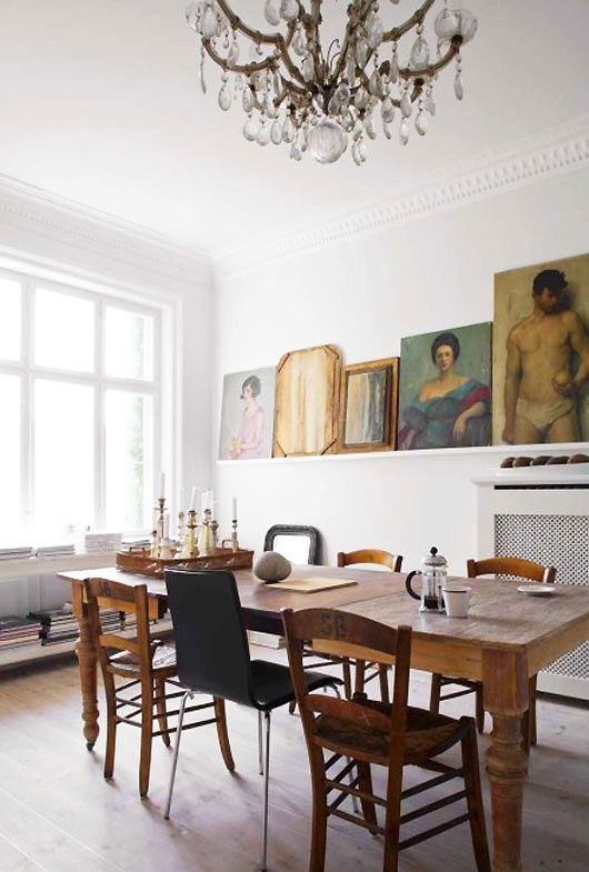 an antique dining table and rustic and modern chairs of wood and metal for a fresher look