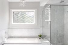 26 white marble tiles in the shower are extended to make a backsplash and cover the bathtub, too