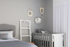 a lovely grey bedroom with a crib