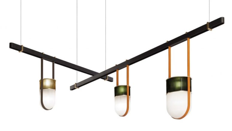Pendant lamps hang from the beams on stripes of saddle leather, which is a support