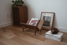 02 The furniture is made of wood and leather and features mid-century modern aesthetics