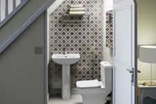 02 a contemporary powder room done with geometric tiles, a wall-mounted shelf for storage