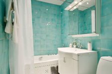 02 turquoise watercolor tiles cover the whole space and look nice with litte white ones on the floor