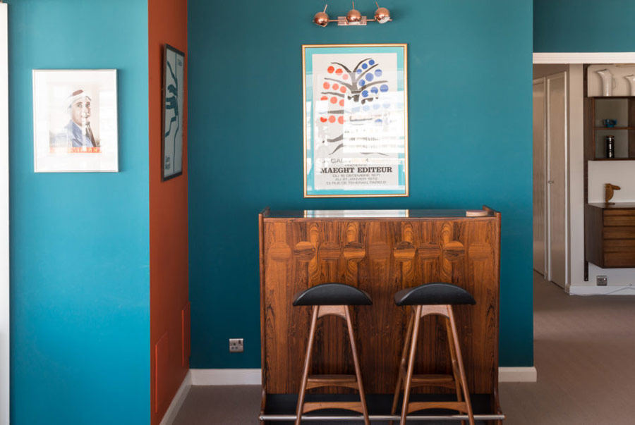 Teal and orange walls are used for color blocking and they remind of the ocean spaces around