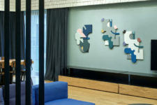 03 The living room is done with a bold blue U-shaped sofa, metal tables and a colorful mosaic rug