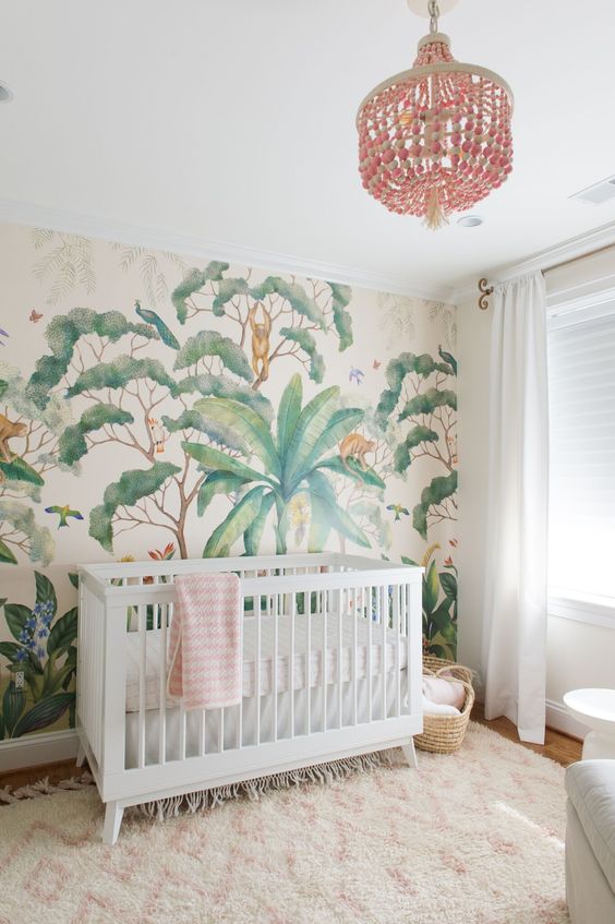 a peaceful tropical space with an eye-catchy wallpaper wall, a pink chandelier, a faux fur rug