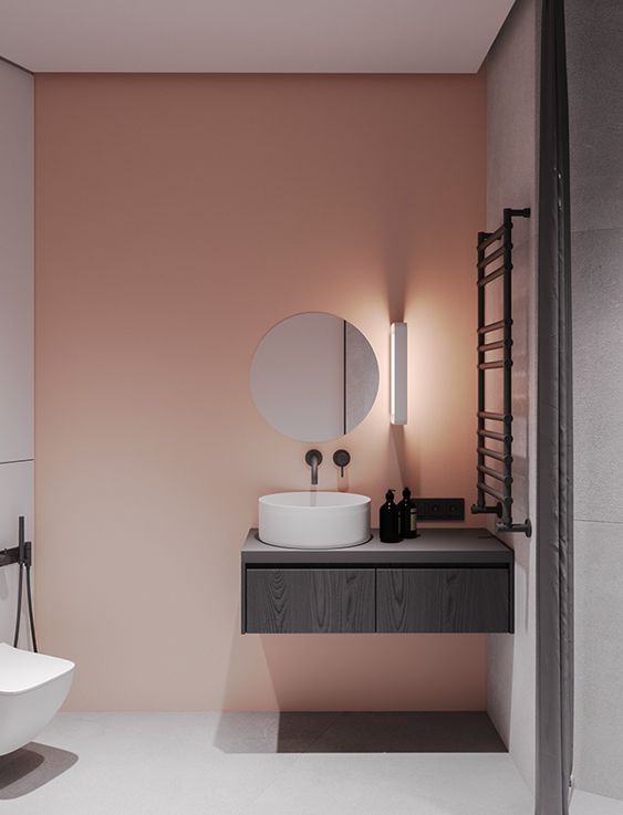a pink painted statement wall to add a splash of color to a minimalist bathroom