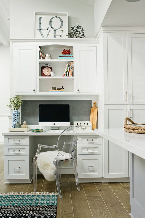 A seamlessly built in office nook in the kitchen, the desk and cabinets made in the same style and look as the kitchen itself
