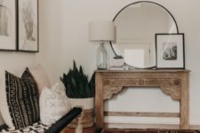 04 a boho entryway with a vintage encrusted console, a woven bench, pillows, artworks and succulents