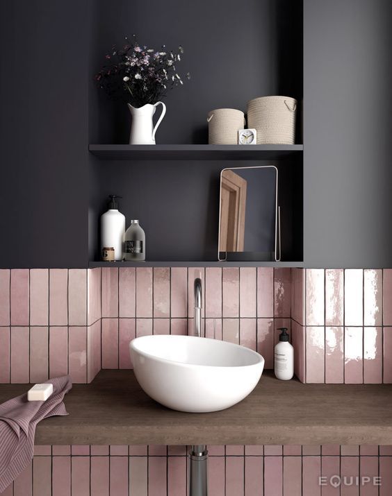 a combo of glossy pink long narrow tiles and a matte black cabinet over them for a chic modern look
