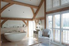 04 a gorgeous refined space with wooden beams and a bathtub zone done with large scale tiles