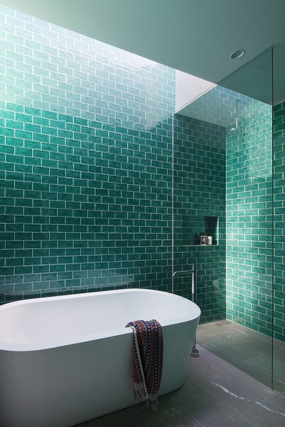 a modern bathroom with turquoise tiles and white grout for a bold space with a splash of color