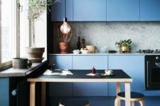05 a blue minimalist kitchen with a grey marble backsplash and a black dining set for a gorgeous look