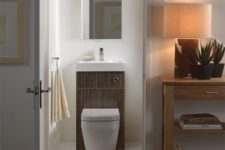 05 a minimalist powder room with a mirror and a sink plus toilet combo – you won’t need more
