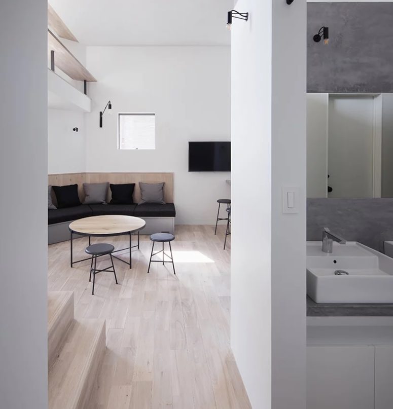 The bathroom is clad with concrete and whites, it's also ultra-minimalist