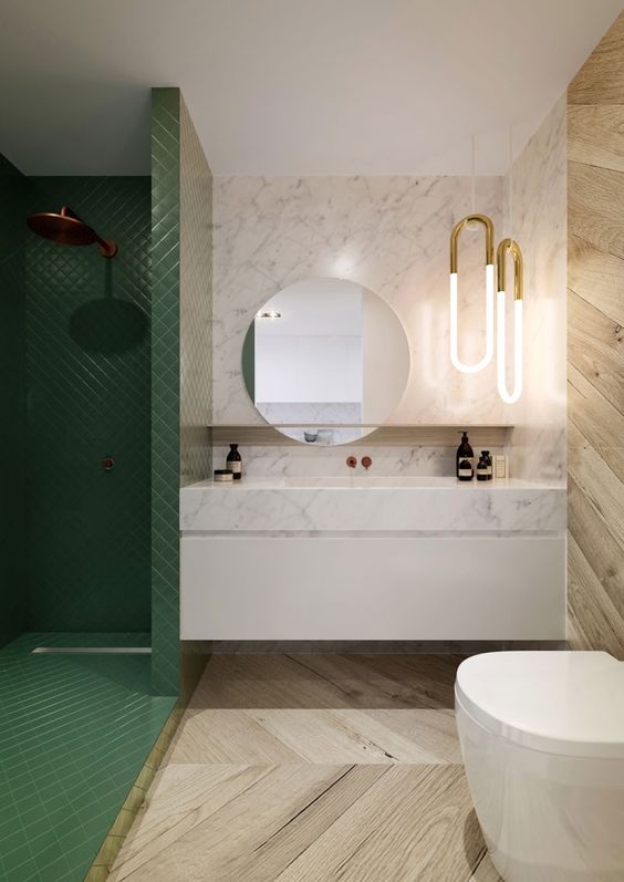 a luxurious look is achieved with the use of marble, wood and green tiles that clad the shower space