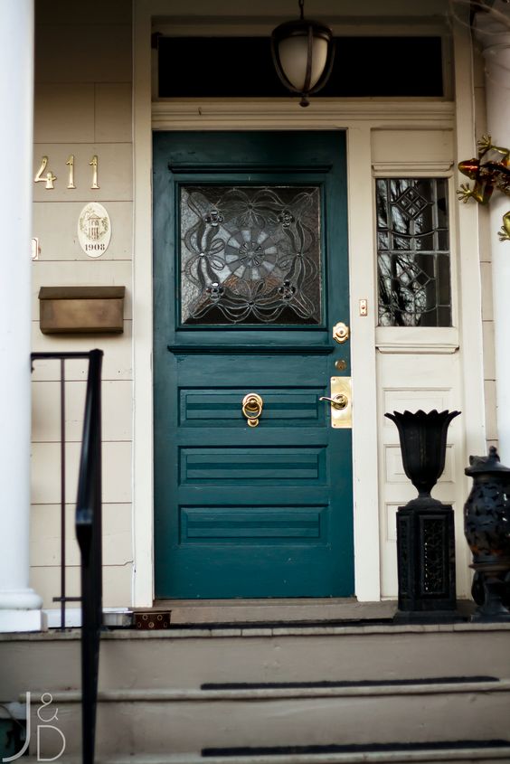 a stylish teal front door with a glass insert and gold detailing looks wow
