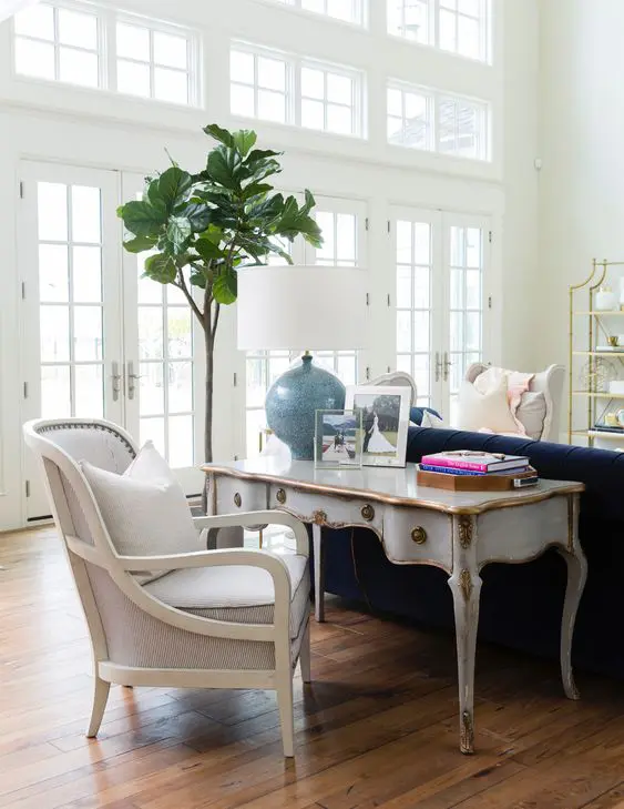 continue the refined space of the living room with a vintage desk and chair that match the space while differ in color
