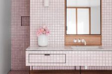 06 glossy light pink tiles covering the floor and walls are calmed down with warm-colored wood and white touches