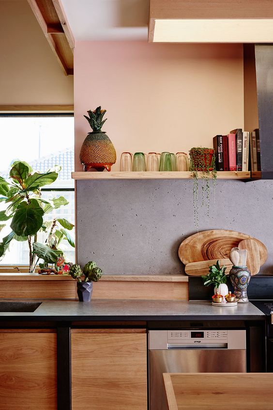 light-colored wood contrasts the raw concrete backsplash, which makes the space cooler