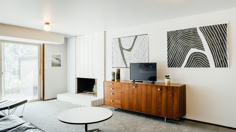 Here's another sitting zone with a brick clad fireplace, monochrome artworks and cool furniture