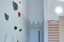 07 The kid’s room is done with a large piece, which includes storage and a bed on top, there’s a real climbing wall