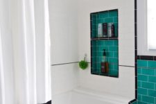 07 a black and white bathroom spruced up with turquoise tiles here and there to add a vibrant feel