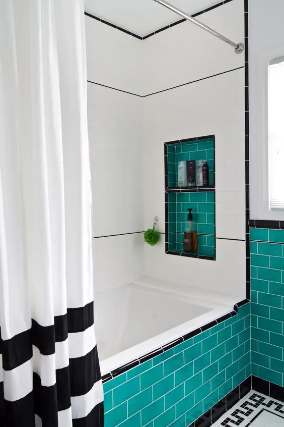 a black and white bathroom spruced up with turquoise tiles here and there to add a vibrant feel
