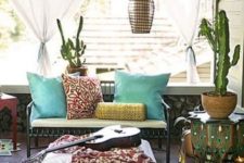 07 a boho porch with printed and colorful textiles, cacti and candle lanterns