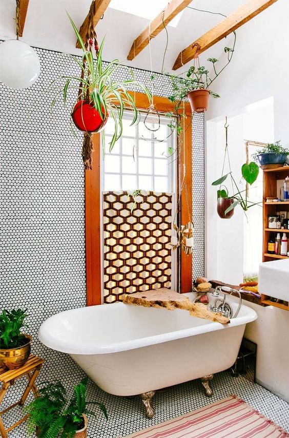 A colorful boho bathroom with penny tiles, rich colored wooden beams, a partly covered window and raw edge wooden items