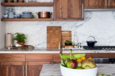 07 a rich-colored wooden kitchen contrasts the white marble backsplash and countertops and together they create a wow effect
