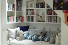a welcoming reading nook with built-in bookshelves and a couch with storage
