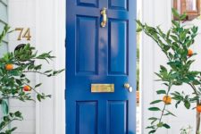 07 an electric blue front door with gold detailing creates a vivacious mood at once