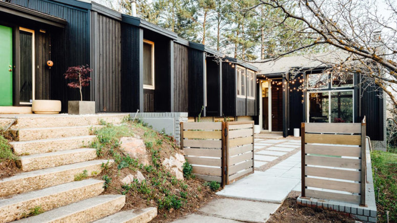 The exterior of the house is clad with black painted wood