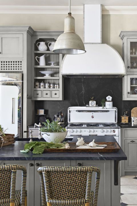 a modern farmhouse kitchen in greys with a chalkboard backsplash that adds a cool touch to the space