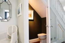 08 a small powder room with black and white decor, an artwork and a jute rug for a cozy feel
