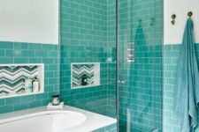 08 elegant turquoise tiles covering the walls and the bathtub itself complemented with white touches