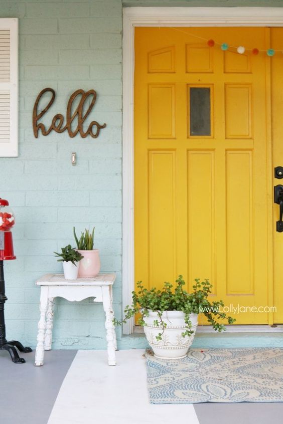 paint your front door bold yellow to add sunlight to the porch