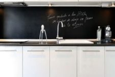 09 a modern white kitchen with a black chalkboard backsplash that helps it stand out and adds depth