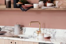 09 a terracotta pink kitchen with open shelving, wood plank cabinets and a white marble backsplash and countertop