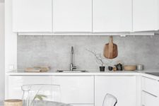 09 a white Scandinavian kitchen is spruced up with a concrete countertop and acrylic chairs