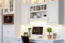 09 a white farmhouse kitchen with a seamless office nook with built-in lights and a large comfy desk