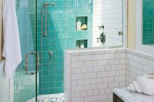 09 glossy turquoise tiles covering the shower wall add color to the bathroom and spruce it up