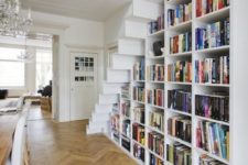 10 a large bookcase built under the stairs is all you need to save the space and acomodate them all