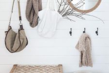 10 a wooden rack, a rope mirror, a basket for storage, a woven bench for a serene boho look