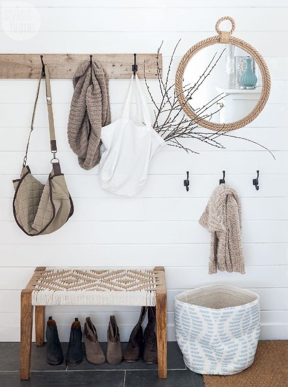 A wooden rack, a rope mirror, a basket for storage, a woven bench for a serene boho look