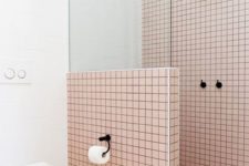 10 light pink tiles are highlighted with black grout and contrasting white touches